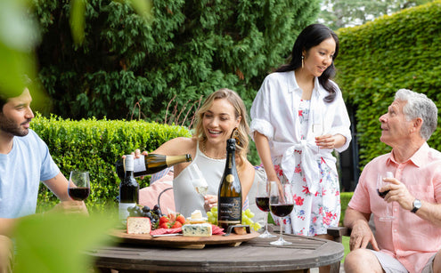 People at a dinner party drinking wine