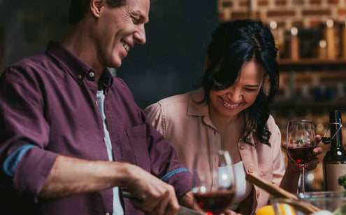 people laughing and drinking wine