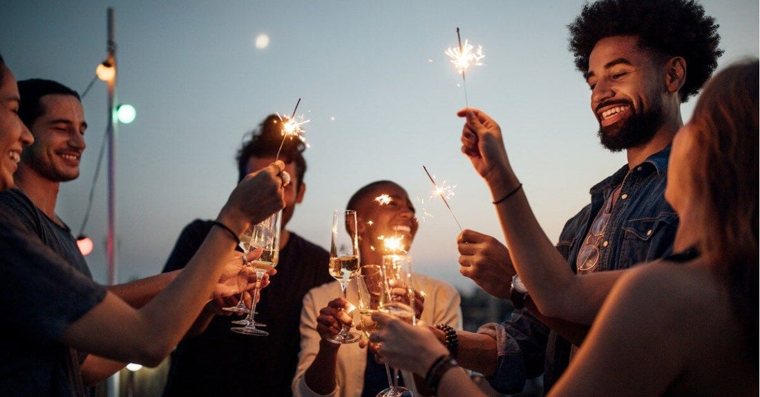 Friends celebrating with wine and sparklers