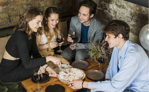 People sitting down and drinking wine