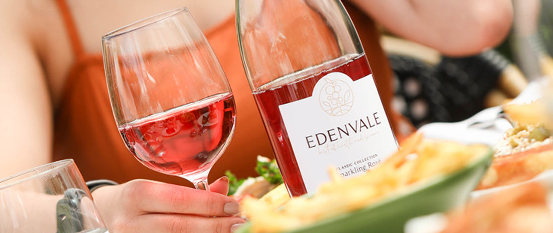 Bottle and glass of Edenvale alcohol-removed Rosé wine on a table with food during outdoor dining