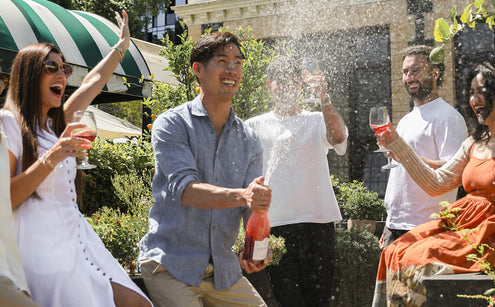 Group of friends celebrating outdoors with Edenvale non-alcoholic sparkling wine at a summer garden gathering in Australia