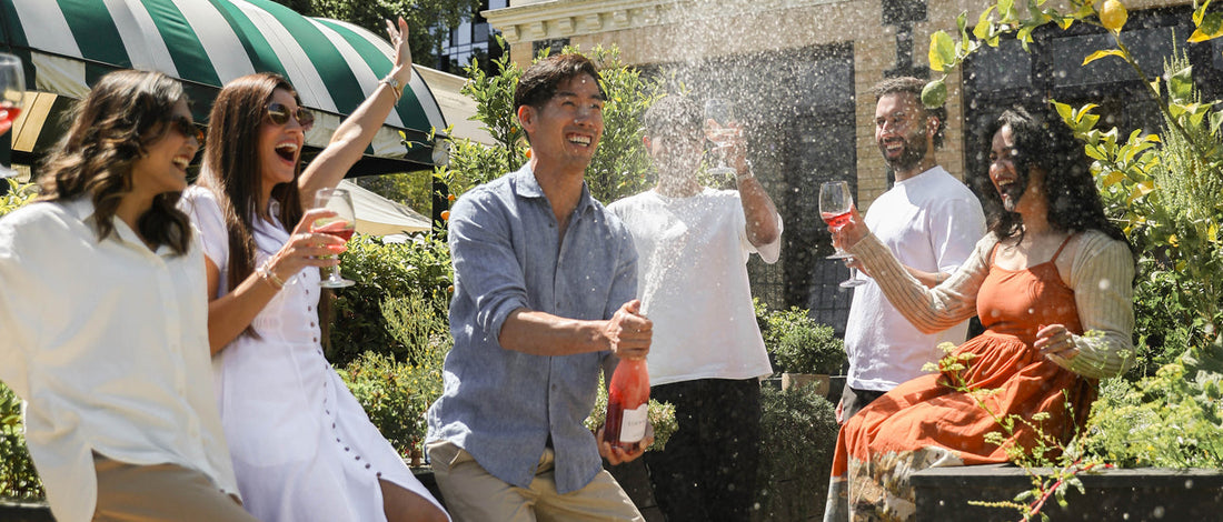 Group of friends celebrating outdoors with Edenvale non-alcoholic sparkling wine at a summer garden gathering in Australia