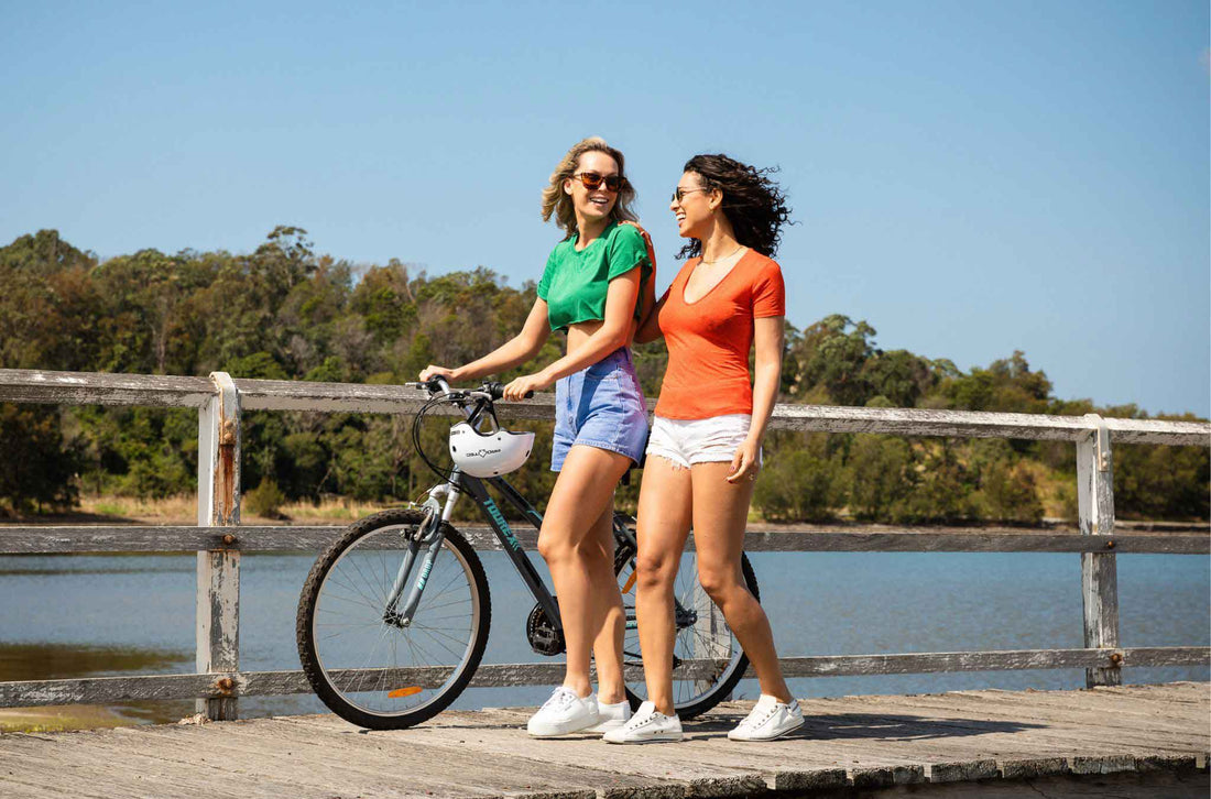Two women walking with a bicycle