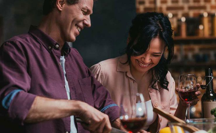 people laughing and drinking wine 