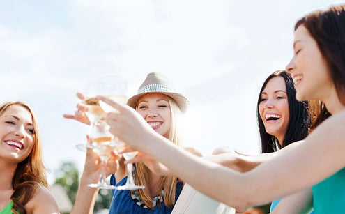 Women clinking wine glasses