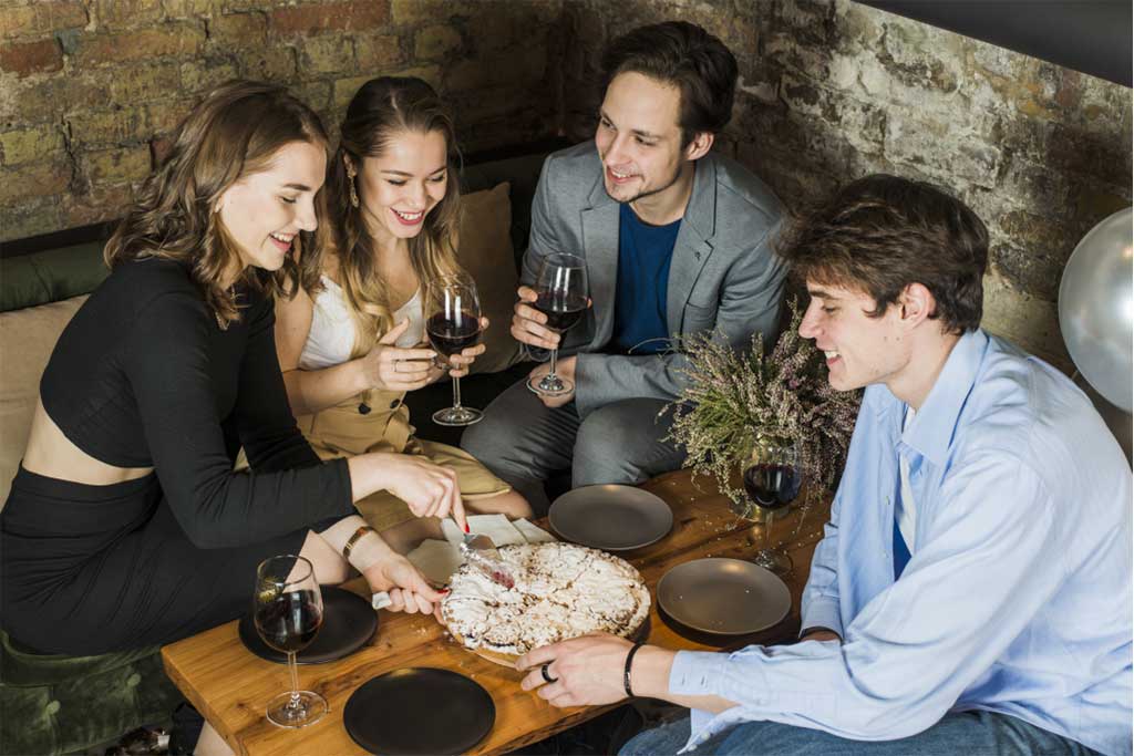 People sitting down and drinking wine