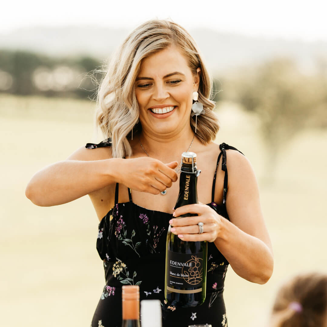 Lady opting a bottle of non-alcoholic sparking wine