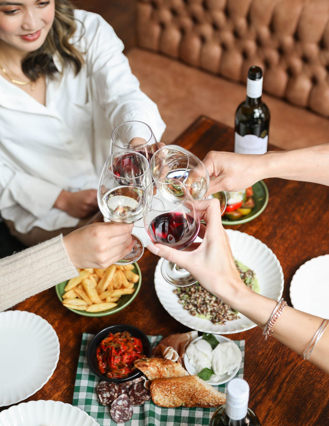 Friends raising a toast with Edenvale over a shared table